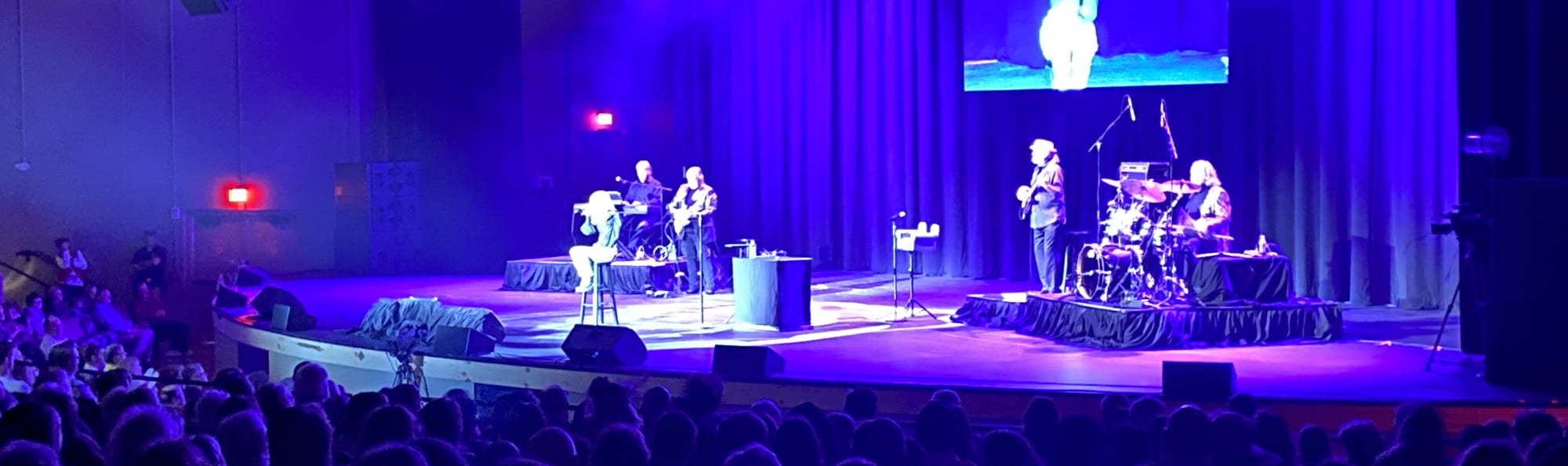signer on stage in chair washed out by the lights Roanoke